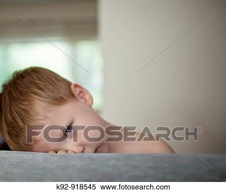 Boy resting on a couch View Large Photo Image Stock Photography - Boy resting on a couch. Fotosearch