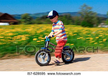 Stock Photography - boy riding bicycle / Like a Bike, in spring, Gossau ZH, Zuerich, Switzerland. Fotosearch