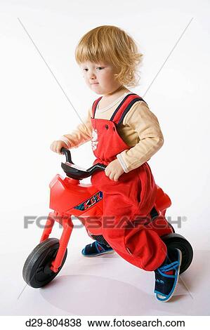 BOY RIDING TOY TRICYCLE View Large Photo Image Stock Photo - BOY RIDING TOY TRICYCLE. Fotosearch