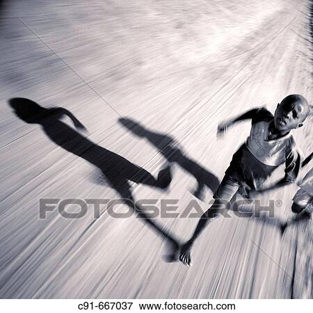 Boy running and shadow. Gambia View Large Photo Image Stock Photo - Boy running and shadow. Gambia. Fotosearch