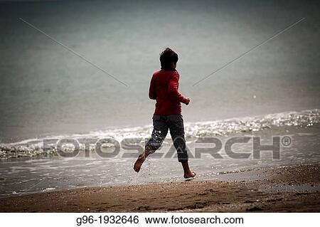 Boy running at the beach View Large Photo Image Stock Photograph - Boy running at the beach. Fotosearch