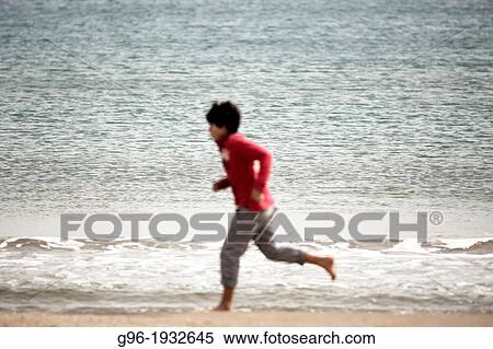 Boy running at the beach View Large Photo Image Stock Photography - Boy running at the beach. Fotosearch