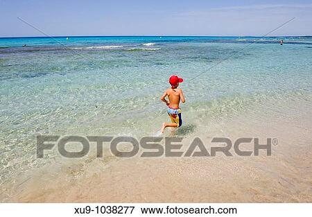 Boy running on beach View Large Photo Image Stock Photo - Boy running on beach. Fotosearch