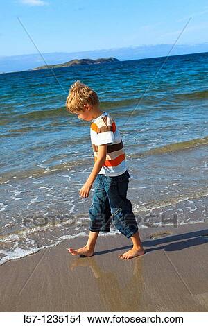 Picture - boy running on sandy beach, Sutherland, Scotland. Fotosearch