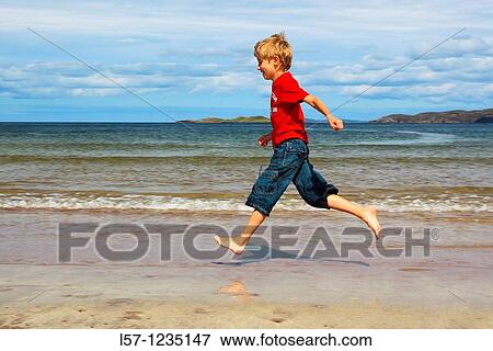 boy running on sandy beach, Sutherland, Scotland View Large Photo Image Stock Photo - boy running on sandy beach, Sutherland, Scotland. Fotosearch