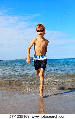 boy running on sandy beach, Sutherland, Scotland View Large Photo Image Stock Photo - boy running on sandy beach, Sutherland, Scotland. Fotosearch