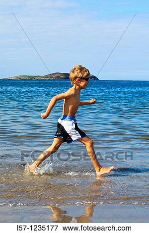 boy running on sandy beach, Sutherland, Scotland View Large Photo Image Stock Photo - boy running on sandy beach, Sutherland, Scotland. Fotosearch