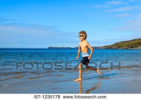 boy running on sandy beach, Sutherland, Scotland View Large Photo Image Stock Photo - boy running on sandy beach, Sutherland, Scotland. Fotosearch