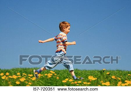 Boy running through filed of Dandelions, in spring, Switzerland. View Large Photo Image Stock Image - Boy running through filed of Dandelions, in spring, Switzerland.. Fotosearch