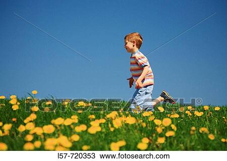 Boy running through filed of Dandelions, in spring, Switzerland. View Large Photo Image Stock Image - Boy running through filed of Dandelions, in spring, Switzerland.. Fotosearch