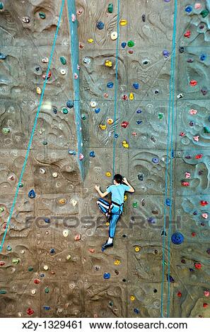 Boy scaling an indoor rock climbing wall Atlanta, Georgia View Large Photo Image Stock Image - Boy scaling an indoor rock climbing wall Atlanta, Georgia. Fotosearch
