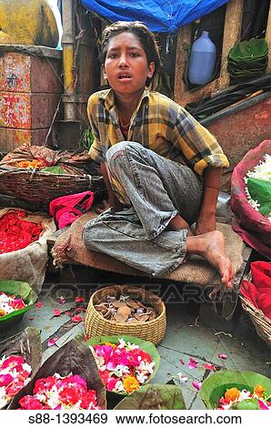 Boy selling flowers to the pilgrims View Large Photo Image Stock Photo - Boy selling flowers to the pilgrims. Fotosearch
