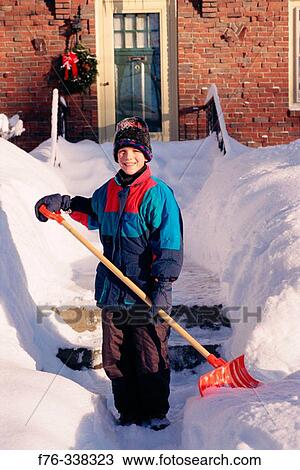 Boy shovelling snow View Large Photo Image Stock Image - Boy shovelling snow. Fotosearch