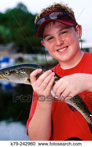 Boy showing a fresh fish View Large Photo Image Stock Image - Boy showing a fresh fish. Fotosearch