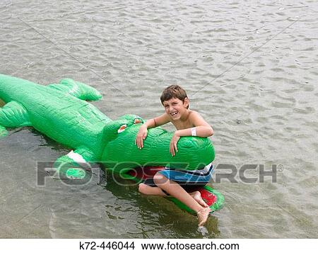 Boy sitting in alligator mouth View Large Photo Image Picture - Boy sitting in alligator mouth. Fotosearch