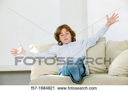 Boy sitting on coach View Large Photo Image Stock Image - Boy sitting on coach. Fotosearch