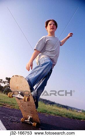 Stock Image - Boy skateboarding. Fotosearch