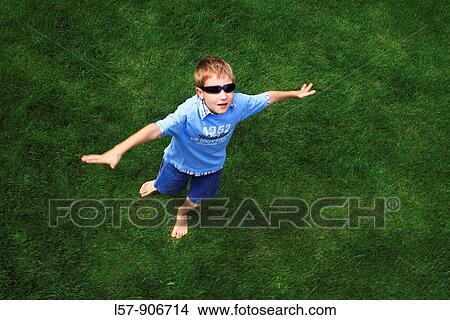 boy spinning around on gras, aerial view, Switzerland View Large Photo Image Picture - boy spinning around on gras, aerial view, Switzerland. Fotosearch