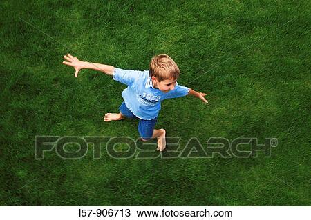 boy spinning around on gras, aerial view, Switzerland View Large Photo Image Stock Image - boy spinning around on gras, aerial view, Switzerland. Fotosearch