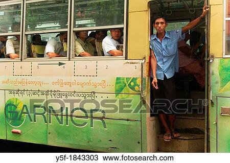 Boy standing at bus entrance at Yangon View Large Photo Image Stock Image - Boy standing at bus entrance at Yangon. Fotosearch
