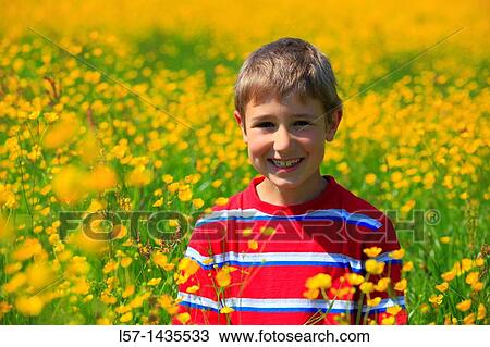 boy standing in blooming field View Large Photo Image Stock Image - boy standing in blooming field. Fotosearch