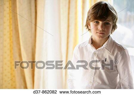 Boy standing looking at camera View Large Photo Image Stock Image - Boy standing looking at camera. Fotosearch