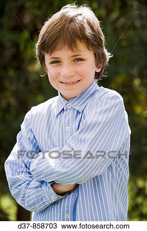 Boy standing outdoors with a striped shirt View Large Photo Image Stock Image - Boy standing outdoors with a striped shirt. Fotosearch