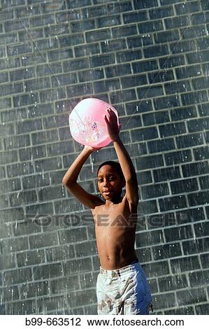 BOY STANDING UNDER, CROWN FOUNTAIN, MILLENNIUM PARK, CHICAGO, ILLINOIS, USA View Large Photo Image Stock Image - BOY STANDING UNDER, CROWN FOUNTAIN, MILLENNIUM PARK, CHICAGO, ILLINOIS, USA. Fotosearch