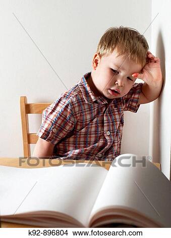 Boy staring at a blank page View Large Photo Image Picture - Boy staring at a blank page. Fotosearch