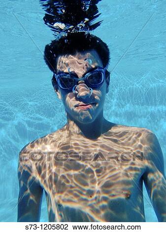 Stock Image - Boy Swimming in Pool. Fotosearch