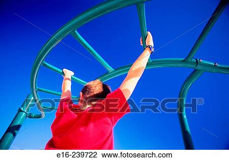 boy swinging from bars View Large Photo Image Stock Image - boy swinging from bars. Fotosearch