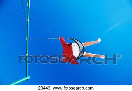 Boy swinging high View Large Photo Image Stock Image - Boy swinging high. Fotosearch