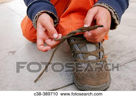 Boy Tying His Sheo Lace View Large Photo Image Stock Image - Boy Tying His Sheo Lace. Fotosearch