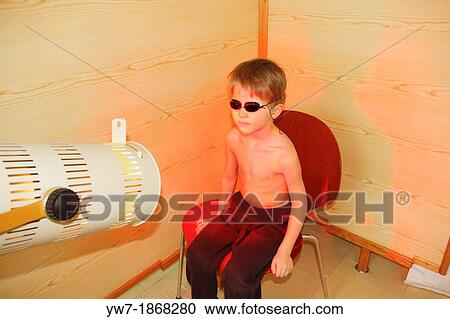 Boy undergoing heat therapy also called thermotherapy View Large Photo Image Stock Image - Boy undergoing heat therapy also called thermotherapy. Fotosearch