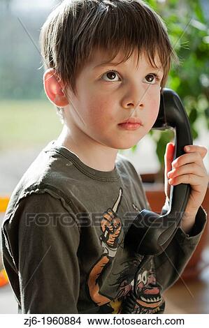 Boy using a retro telephone. View Large Photo Image Picture - Boy using a retro telephone.. Fotosearch