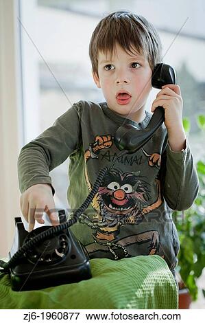 Boy using a retro telephone. View Large Photo Image Stock Photo - Boy using a retro telephone.. Fotosearch