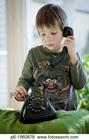 Boy using a retro telephone. View Large Photo Image Stock Photo - Boy using a retro telephone.. Fotosearch