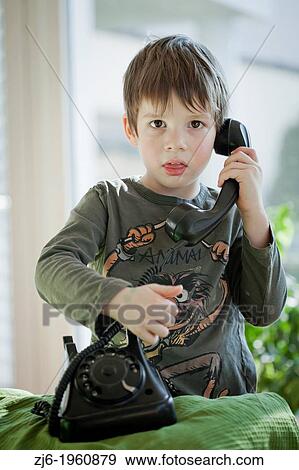 Boy using a retro telephone. View Large Photo Image Stock Photo - Boy using a retro telephone.. Fotosearch