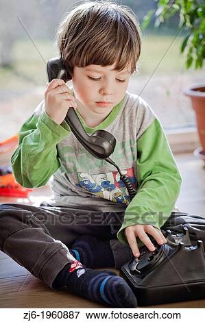 Boy using a retro telephone. View Large Photo Image Stock Photo - Boy using a retro telephone.. Fotosearch