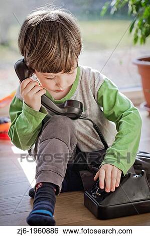 Boy using a retro telephone. View Large Photo Image Stock Photograph - Boy using a retro telephone.. Fotosearch