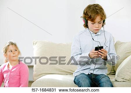 Boy using smartphone View Large Photo Image Stock Image - Boy using smartphone. Fotosearch
