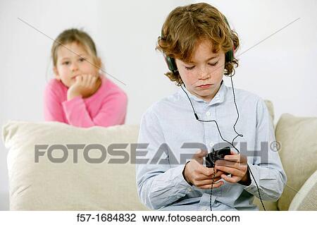 Boy using smartphone View Large Photo Image Stock Image - Boy using smartphone. Fotosearch