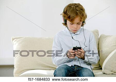Boy using smartphone View Large Photo Image Stock Image - Boy using smartphone. Fotosearch