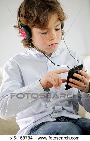 Boy using smartphone View Large Photo Image Stock Image - Boy using smartphone. Fotosearch