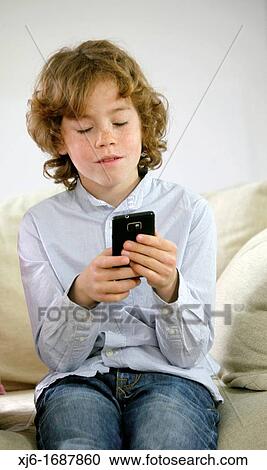 Boy using smartphone View Large Photo Image Stock Image - Boy using smartphone. Fotosearch