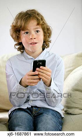 Stock Image - Boy using smartphone. Fotosearch