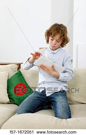 Boy using tablet computer View Large Photo Image Stock Image - Boy using tablet computer. Fotosearch
