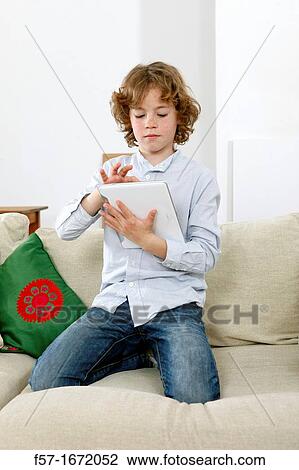 Boy using tablet computer View Large Photo Image Stock Image - Boy using tablet computer. Fotosearch
