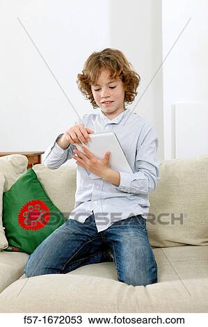 Boy using tablet computer View Large Photo Image Stock Image - Boy using tablet computer. Fotosearch