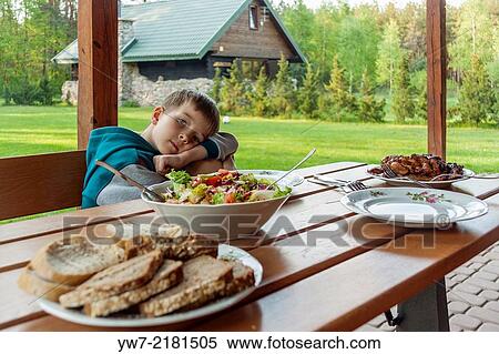 Boy waiting for a meal by the table. View Large Photo Image Stock Photography - Boy waiting for a meal by the table.. Fotosearch